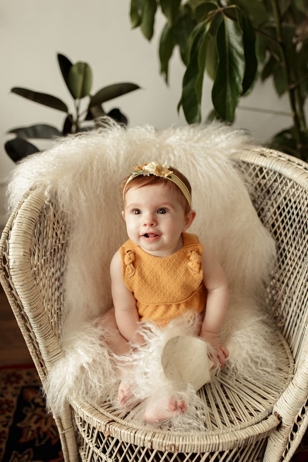 beautiful baby girl on vintage chair in baby session 