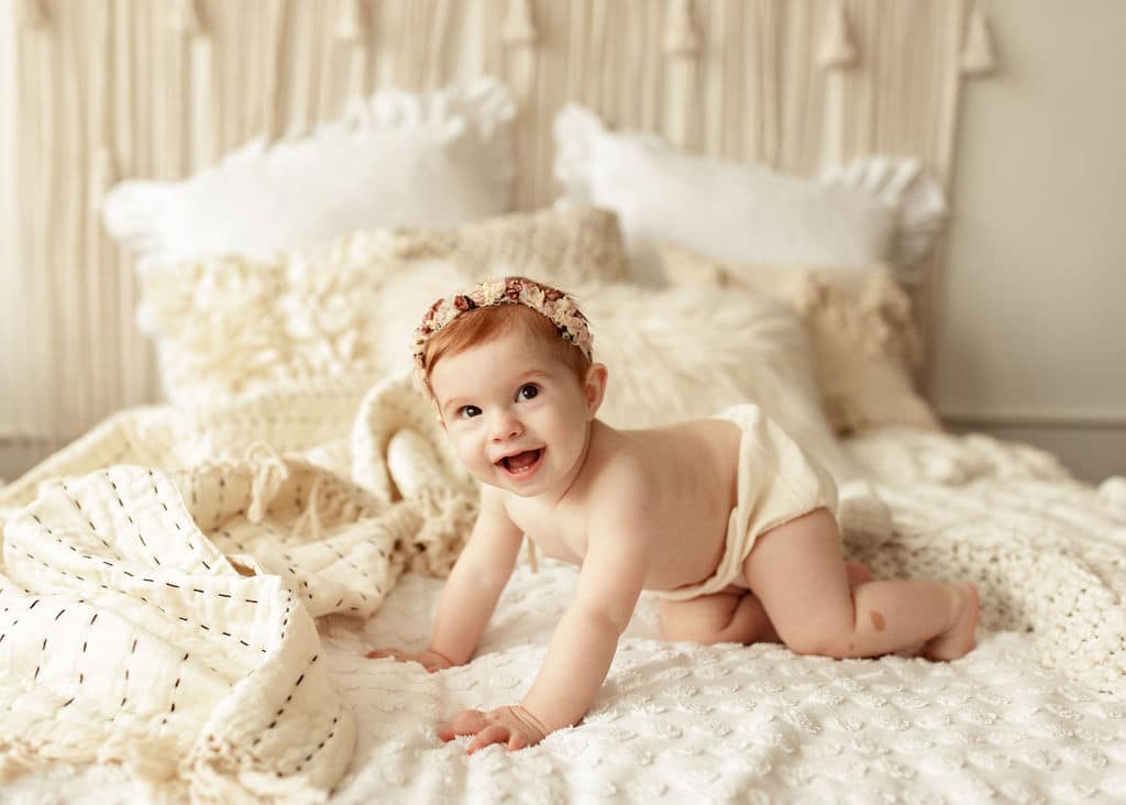 Baby girl on white and cream background