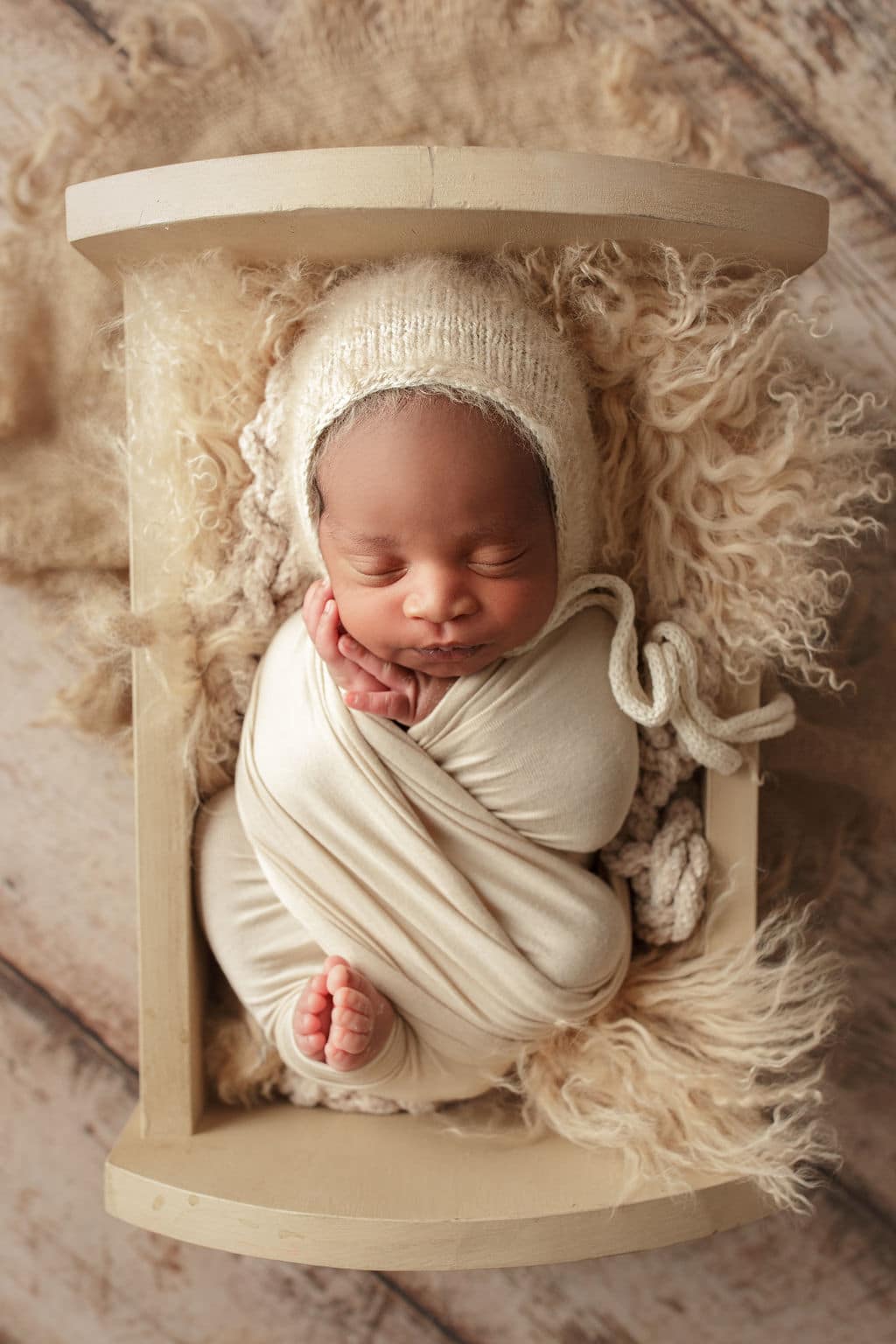 baby boy with comfy hat and swaddle 