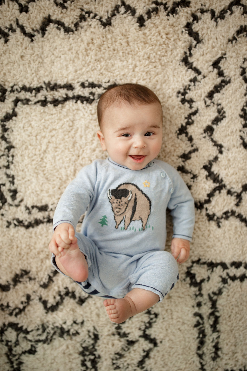 4 month old baby boy playing with his toes