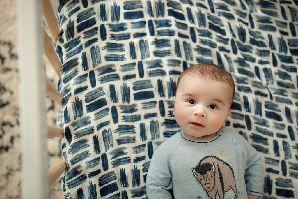 baby boy relaxing in his crib