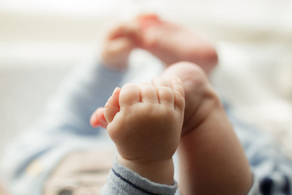 close up of baby grabbing his toes 