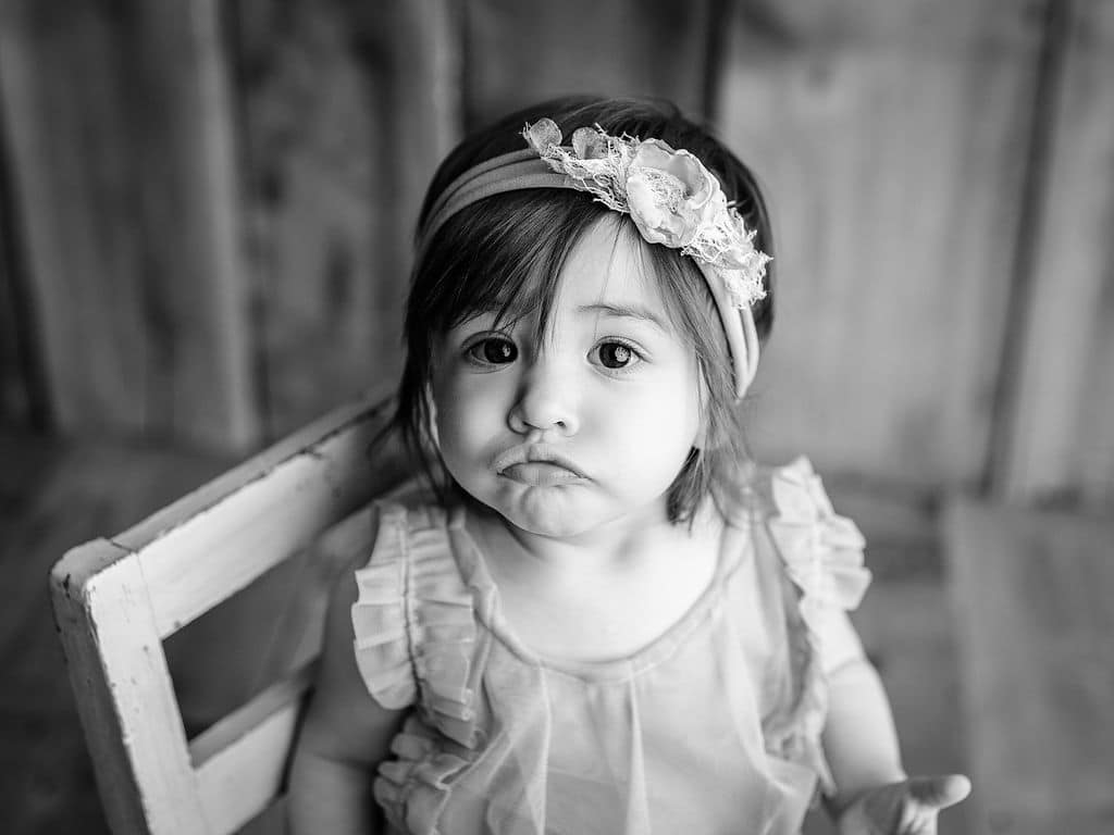 black and white baby blowing a kiss 