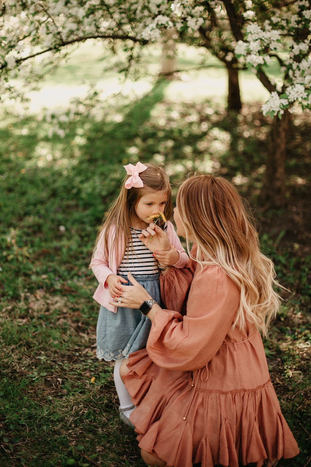 sweet little girl brings her mom a flower 