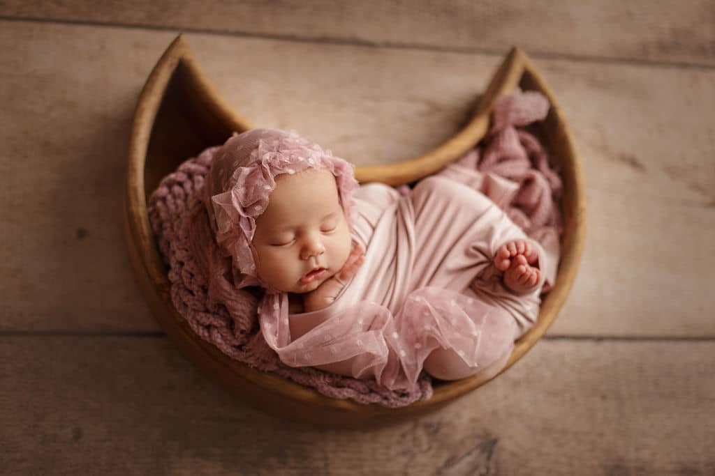 baby girl in moon bucket prop