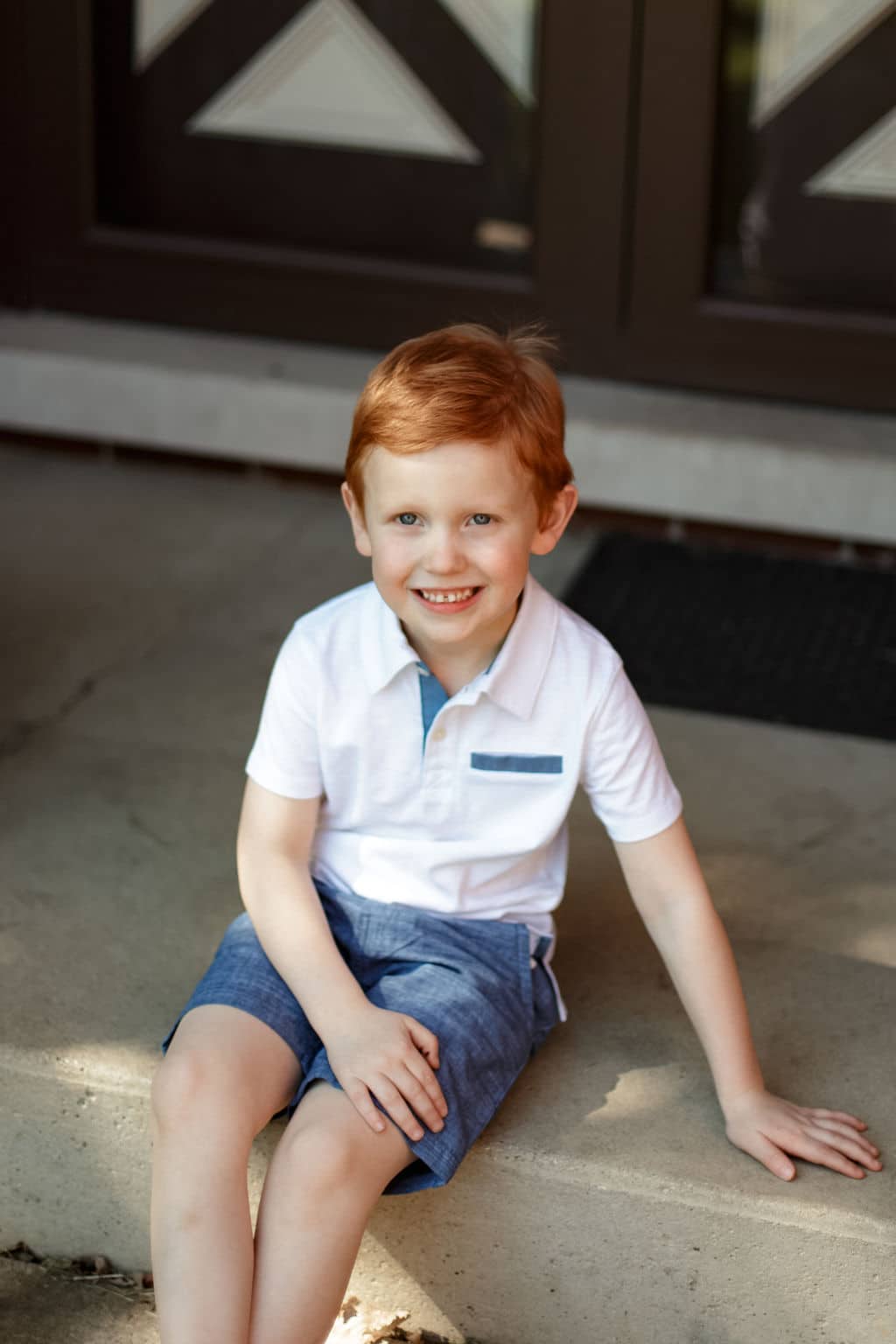 sweet redhead boy on his porch