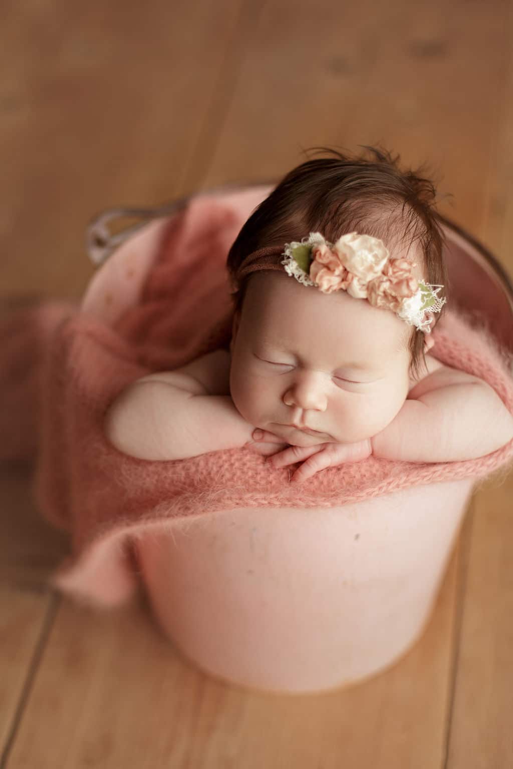 baby girl in pink bucket