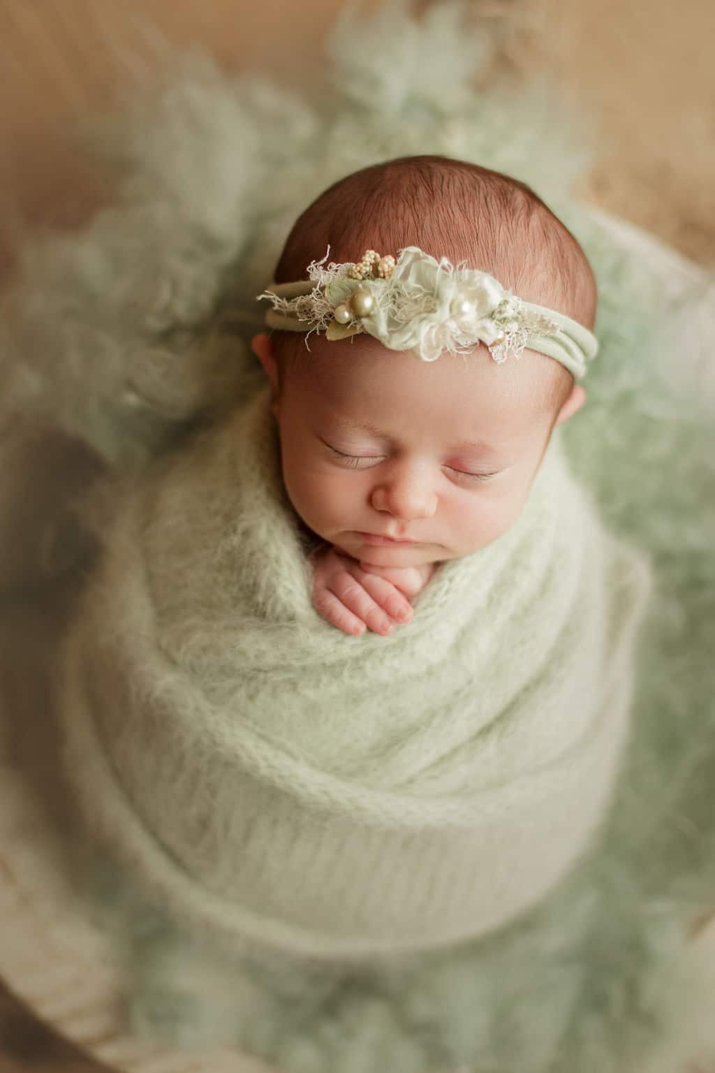 baby girl in soft green