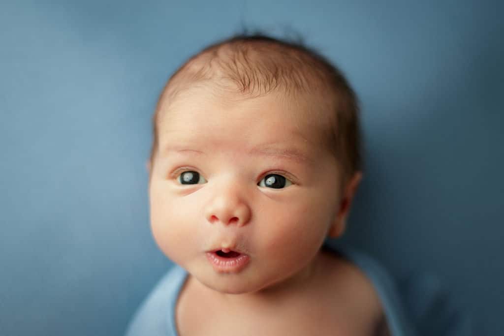 newborn boy with adorable expression