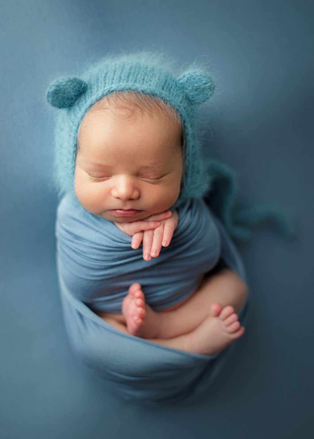 baby boy in bear hat in blue