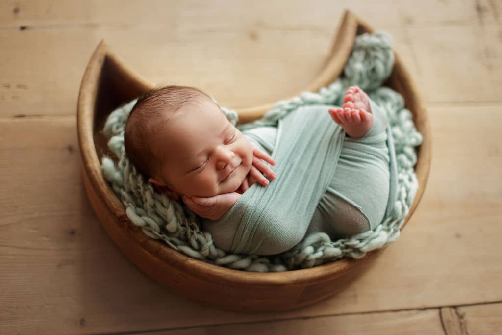 sweet smiling baby boy in moon prop