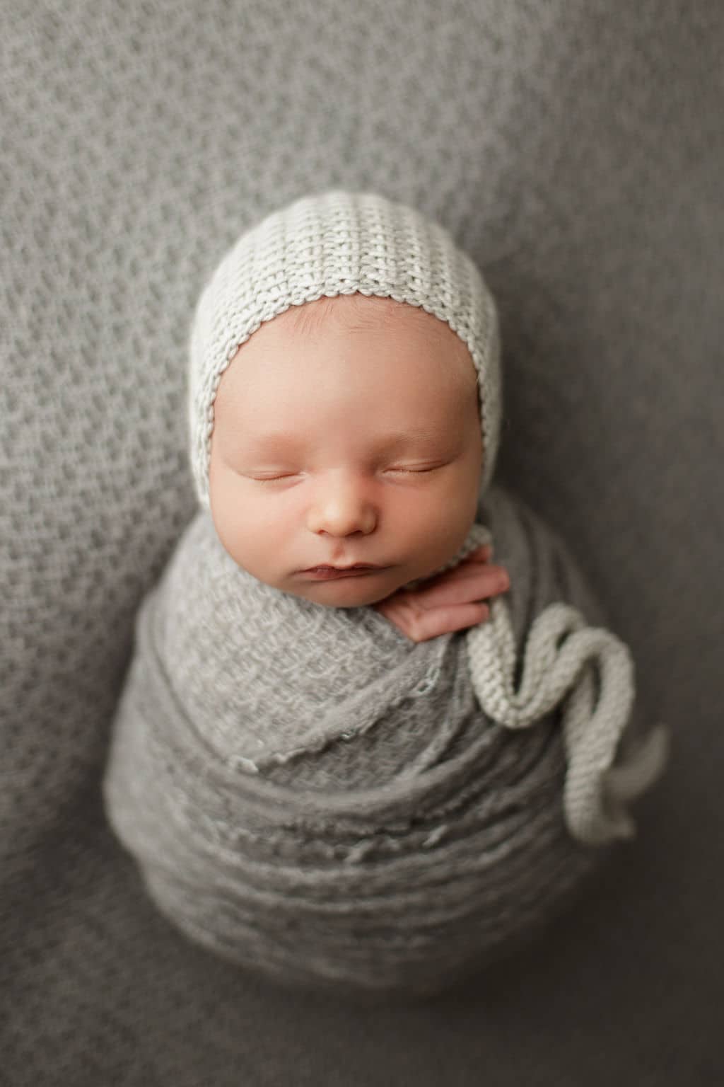 newborn baby boy swaddled