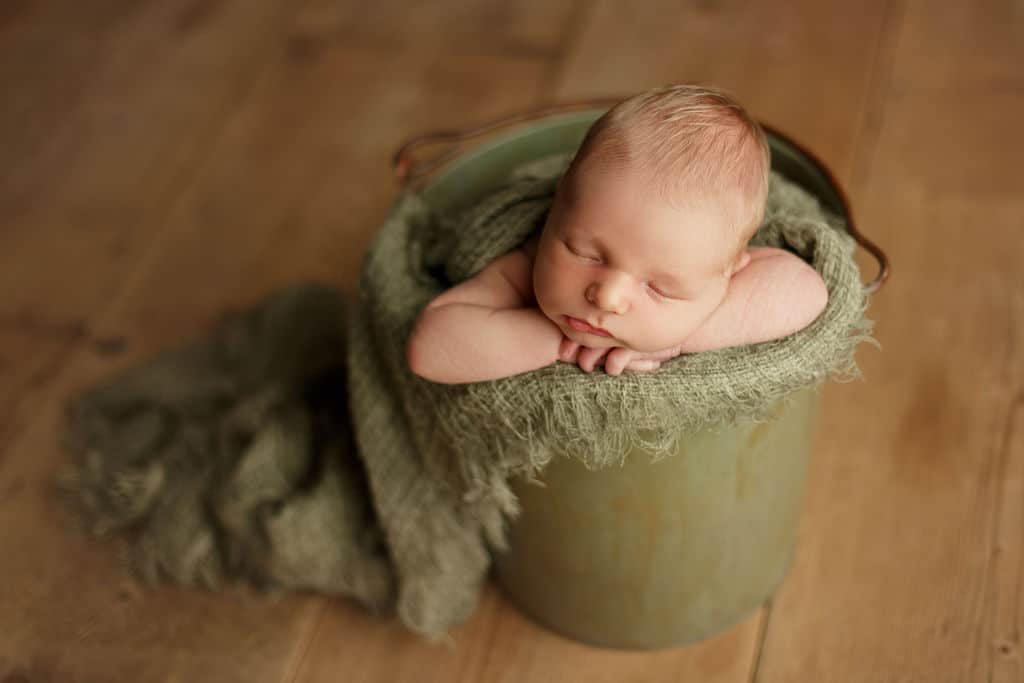 baby boy in green bucket