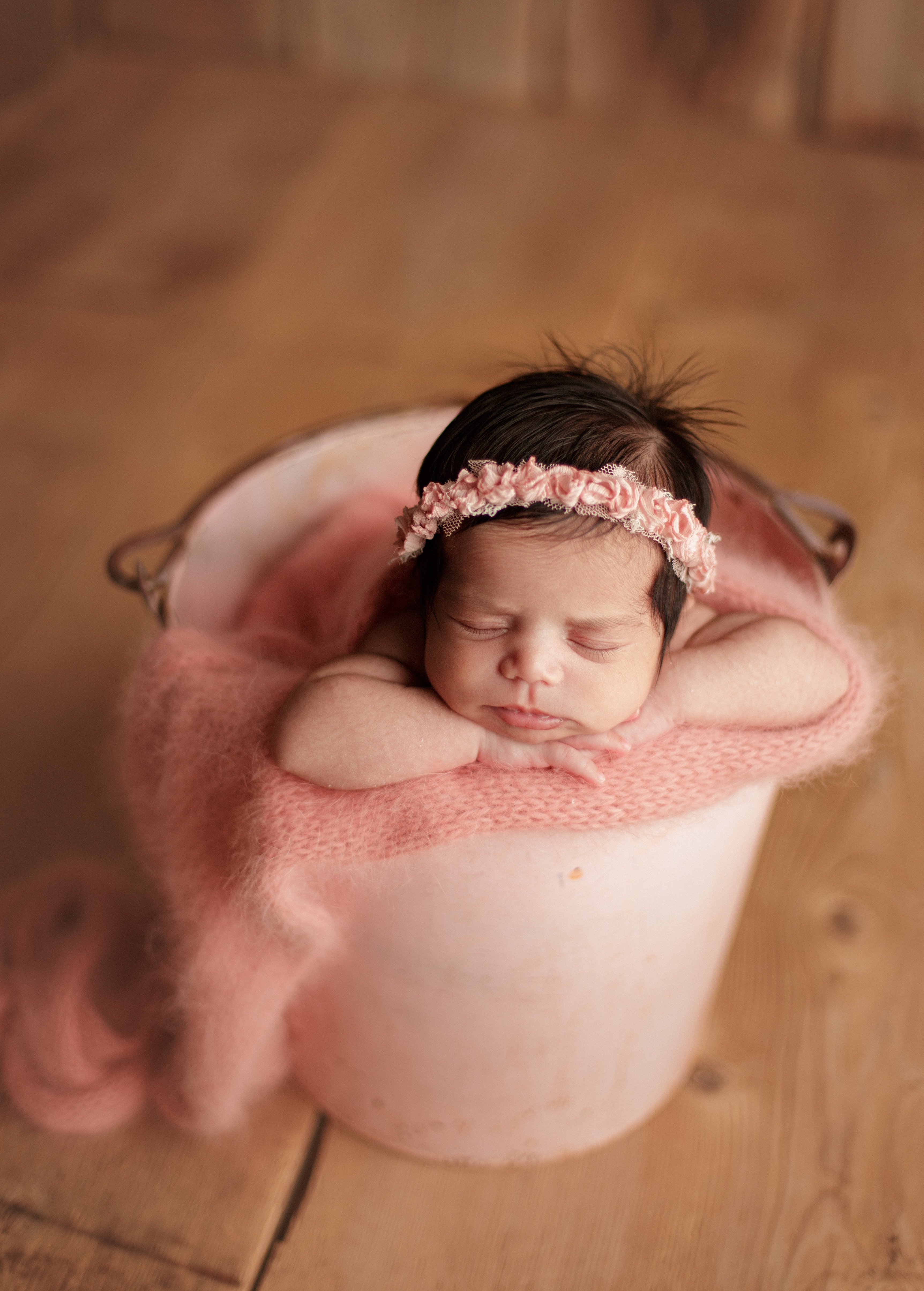 baby girl in basket in pink