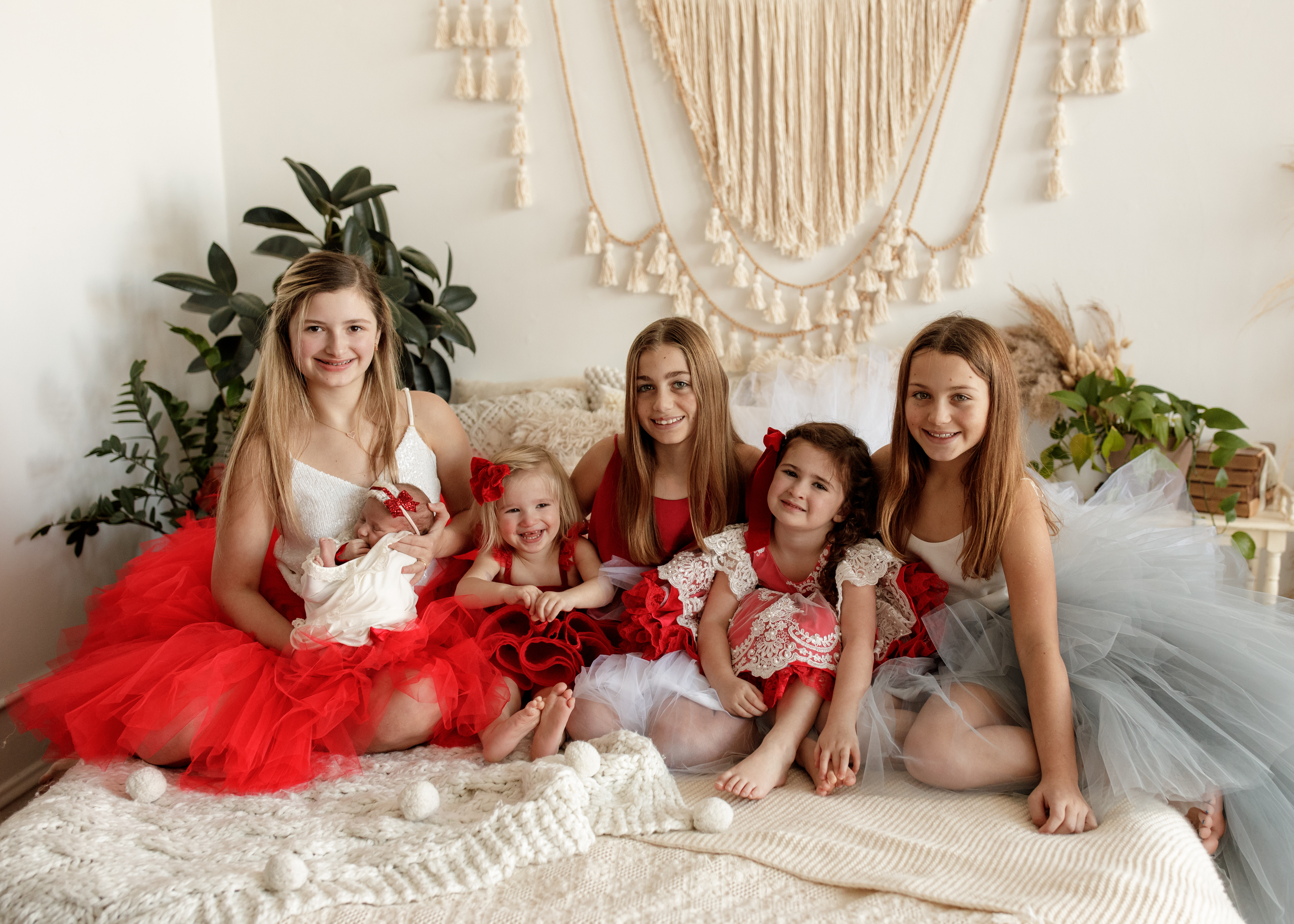 newborn photo shoot with lots of big sisters