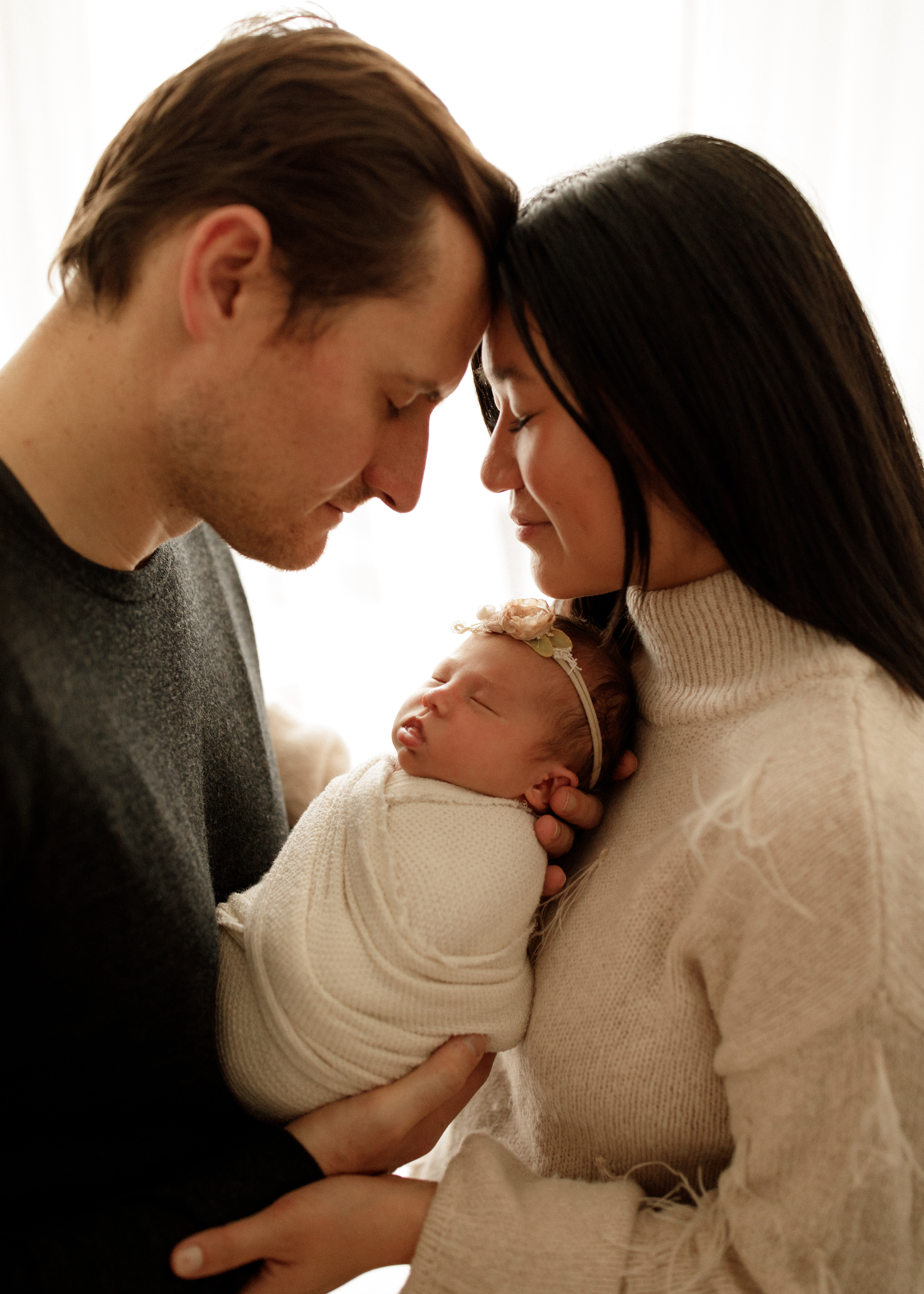 Mom and Dad with newborn baby girl in Chicago studio