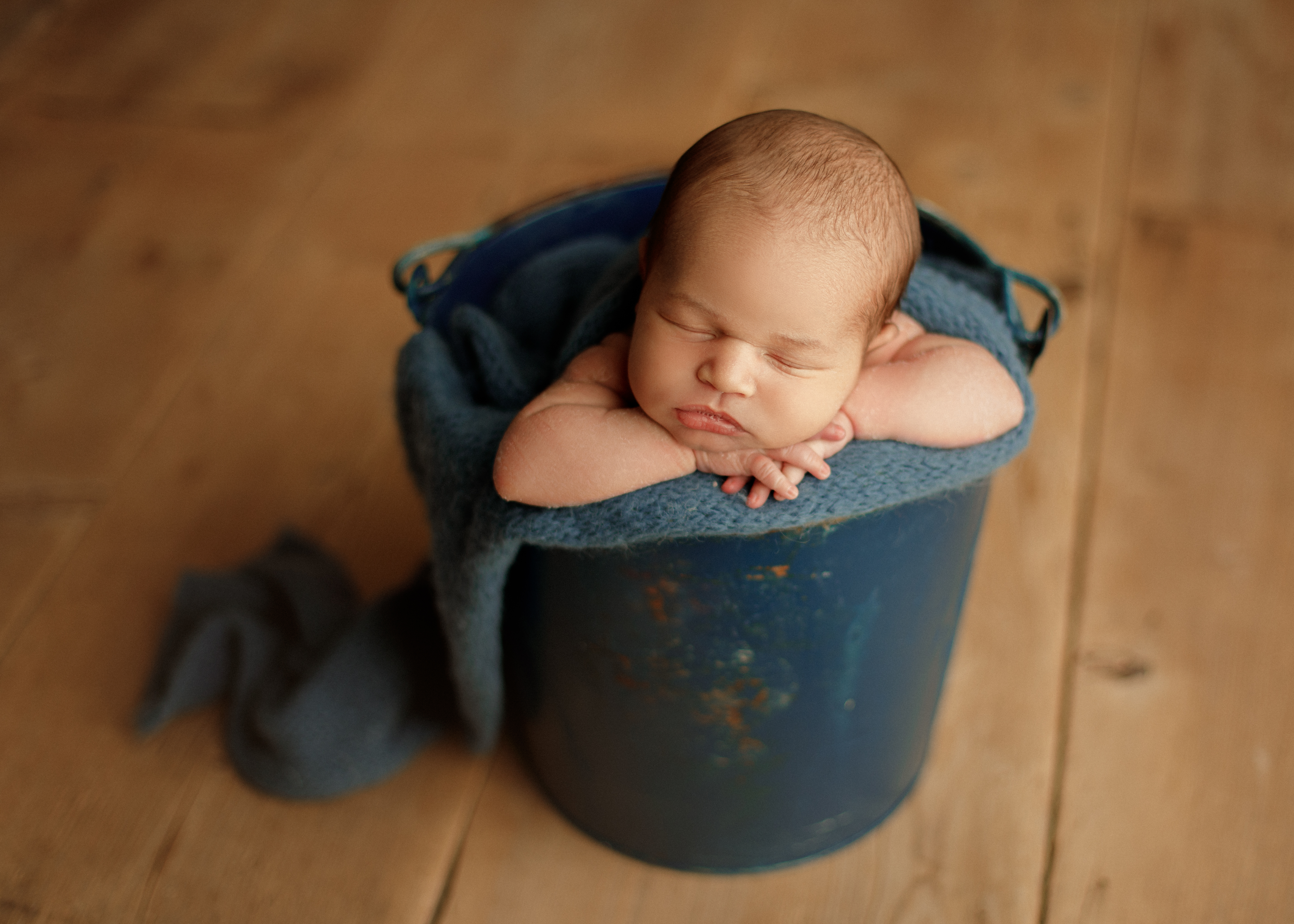 newborn baby boy in bucket pose