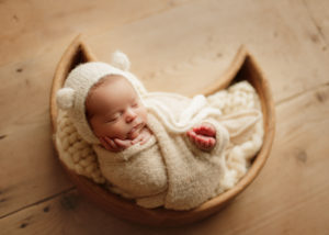 newborn baby in moon pose