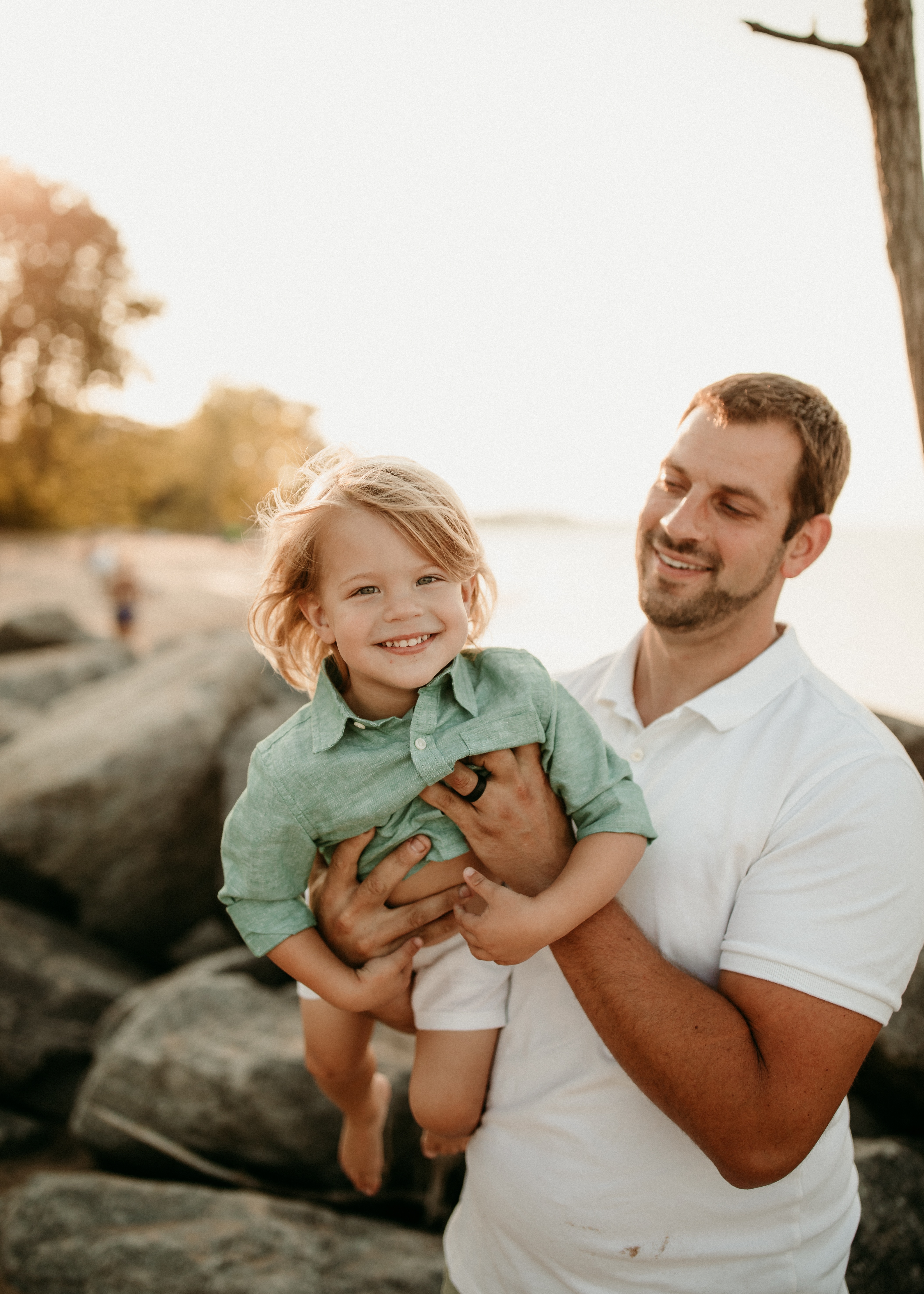 father and son playing at family beach photo shoot Chicago