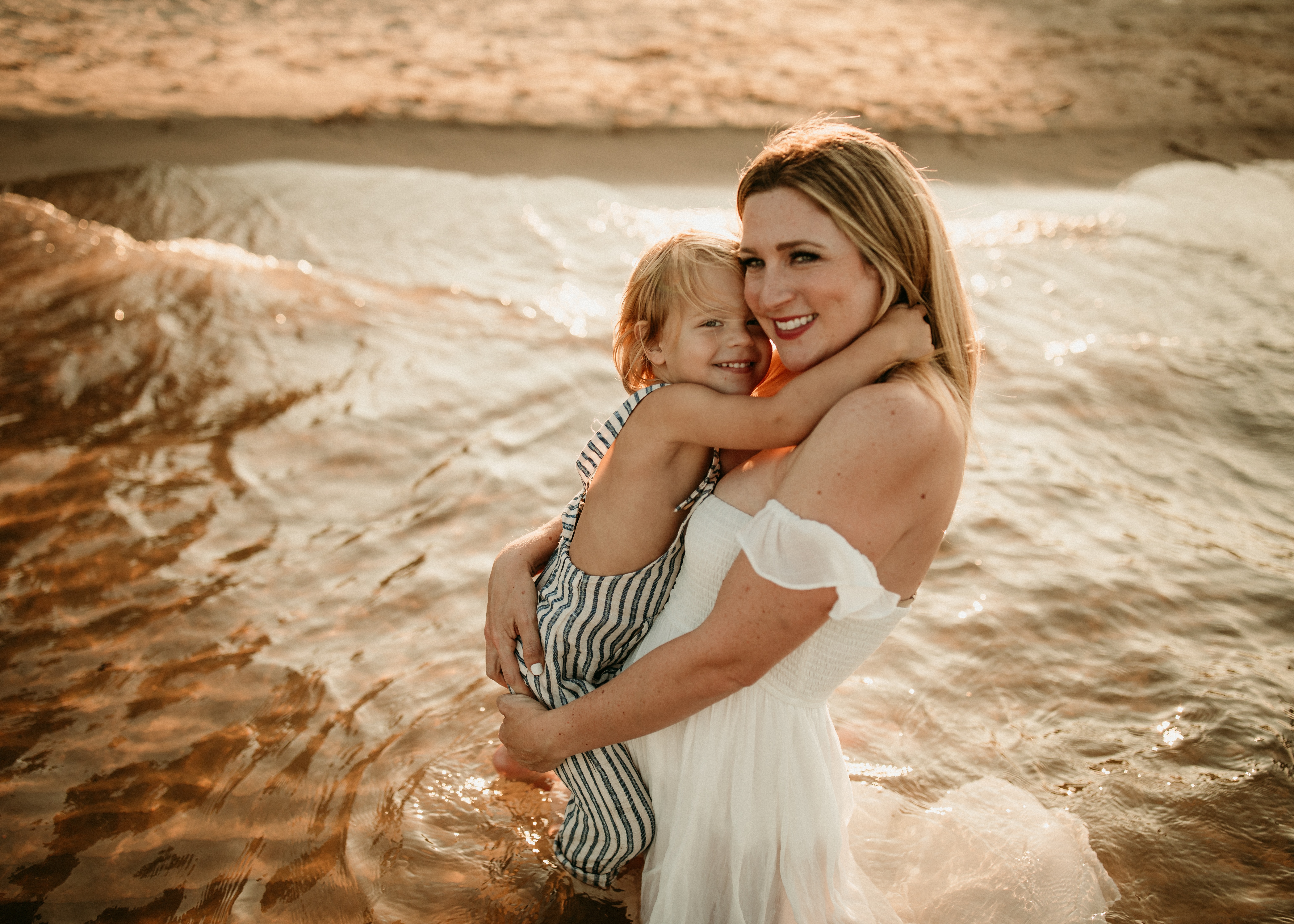 Mom and son snuggles on the beach