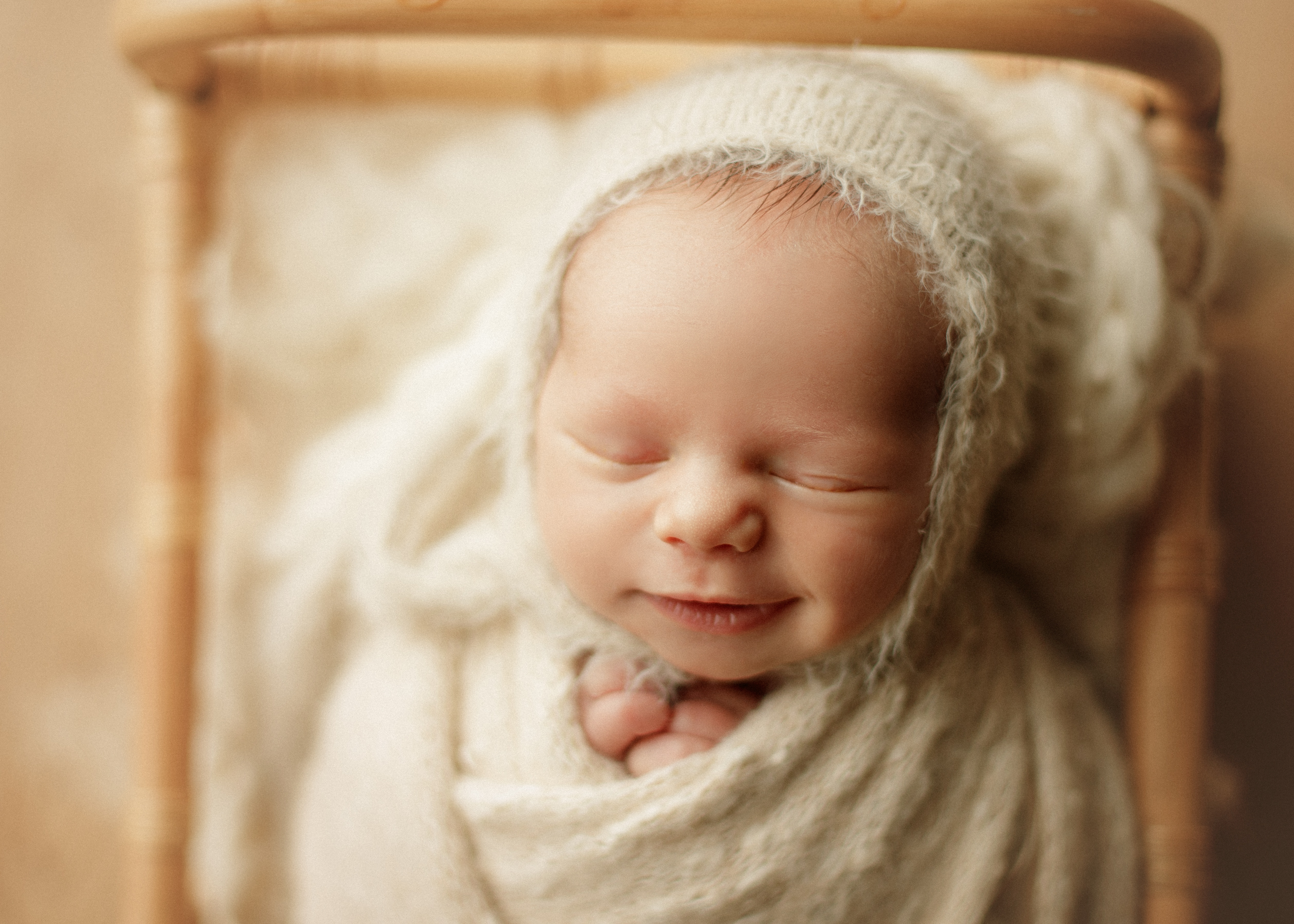 smiling newborn baby boy at photo shoot